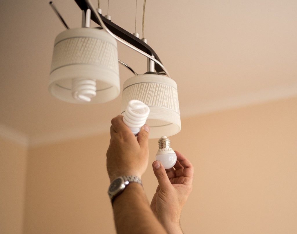 Person changing the light bulbs