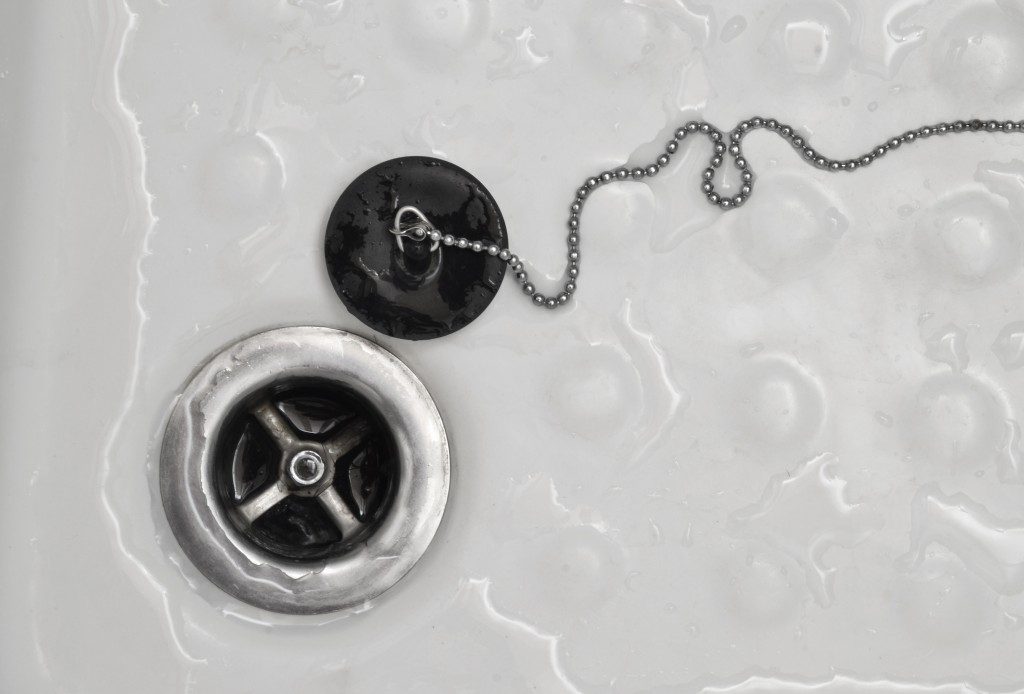 Bathroom drain with rubber stopper