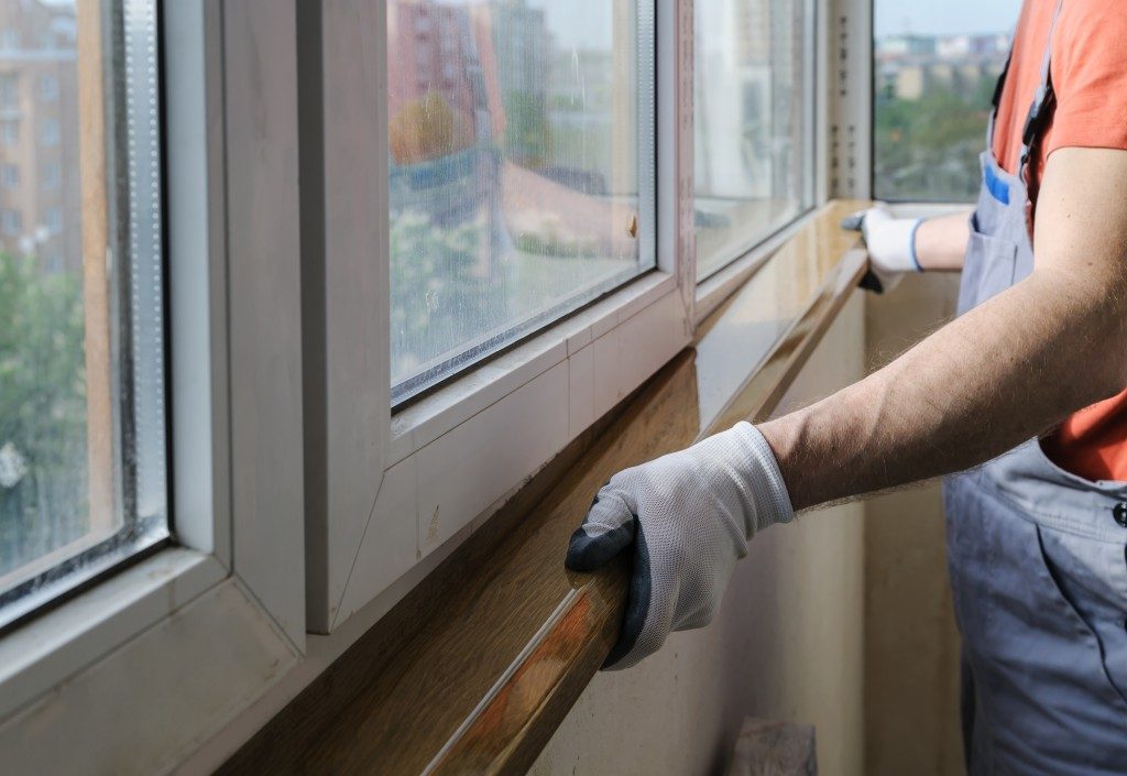 man installing window frames