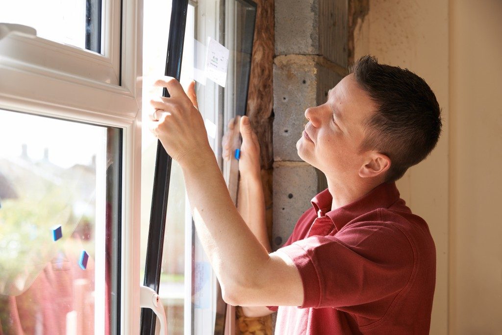 Man Installing New Windows In House