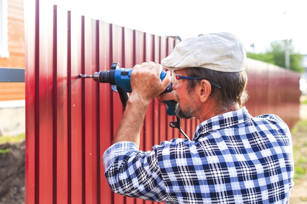 man installing fence