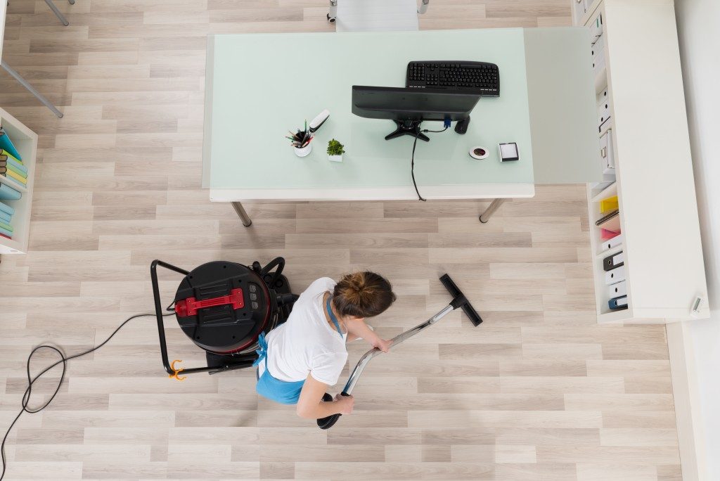 top view of a person vacuuming the floor