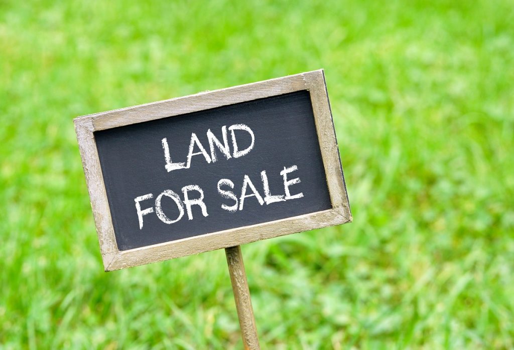 land for sale sign on grass