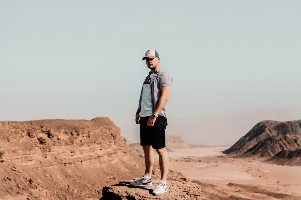 man standing in the middle of the desert
