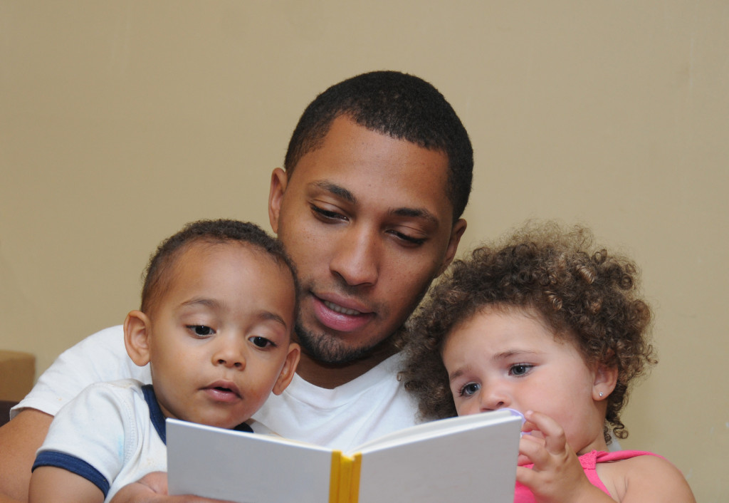 Father reading for one male and one female kids