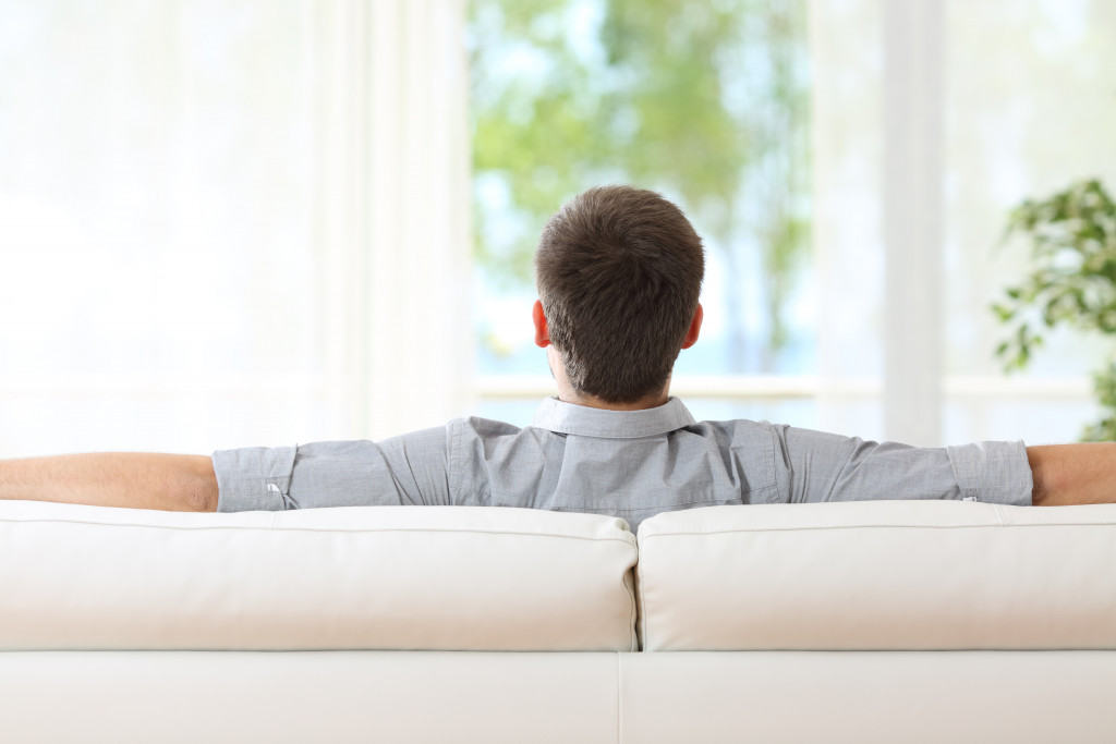 man relaxing on a couch