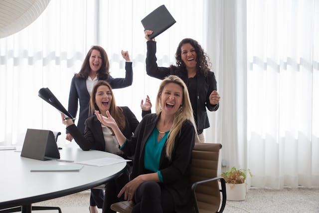 Happy Women by a Conference Room Table 
